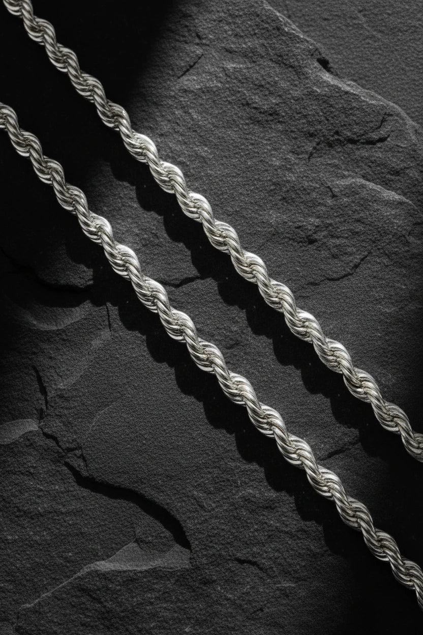 men's sterling silver rope chains on dark stone background