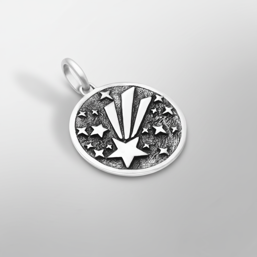 Shooting star pendant close-up detail on light grey background, showcasing craftsmanship and design.