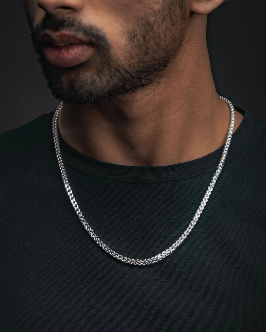 Man in a black tshirt wearing Sterlings silver franco chain on neck