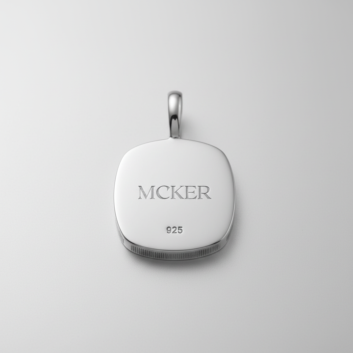 Back of MCKER cheetah pendant displaying authentic 925 sterling silver hallmark and brand logo.