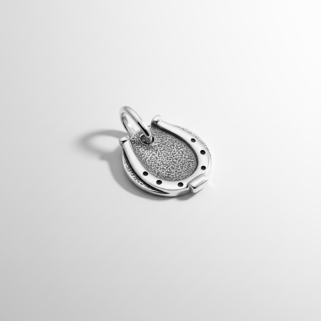 Close-up of men's sterling silver horseshoe pendant with artisan craftsmanship details