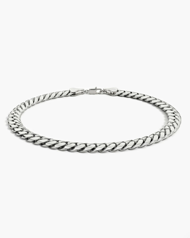 Men’s 5mm sterling silver Cuban link bracelet shown from a low side angle.