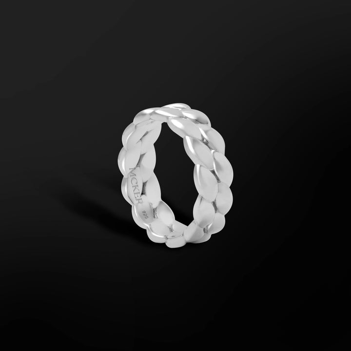 Miami Cuban ring in sterling silver with bold sculpted links, shown at an angled view on black