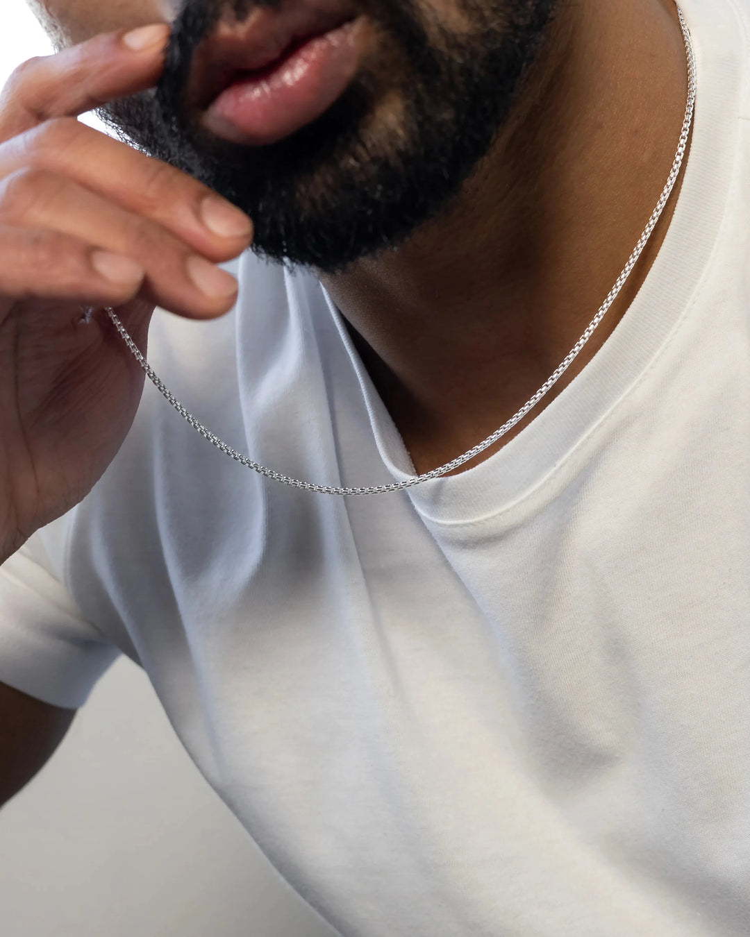 1.6mm round box chain in sterling silver worn on neck with white t-shirt