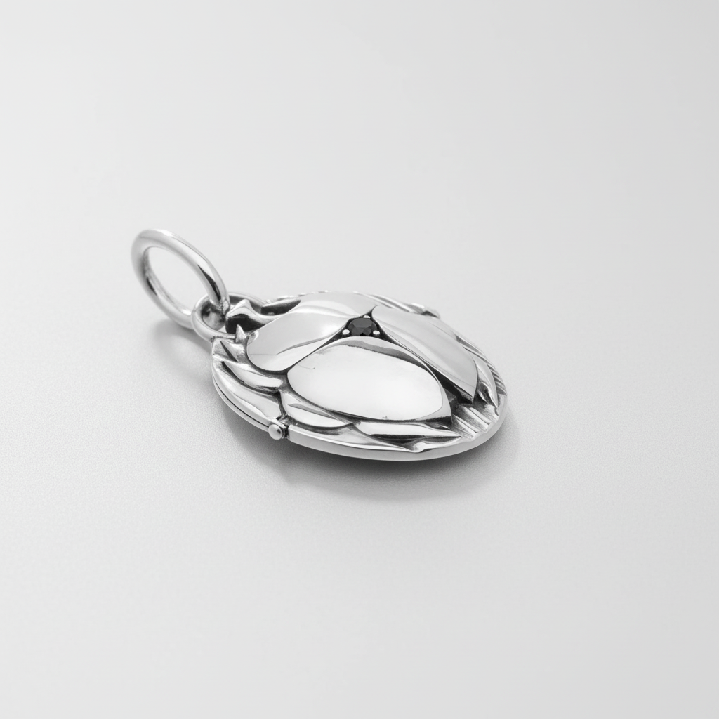 MCKER scarab pendant angled view displaying dimensional craftsmanship and textured sterling silver beetle features.